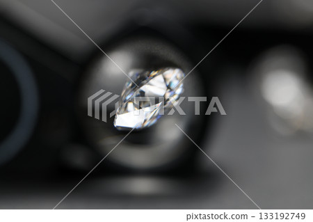 A close up of a diamond with a magnifying glass A close up of a diamond with a magnifying glass 133192749