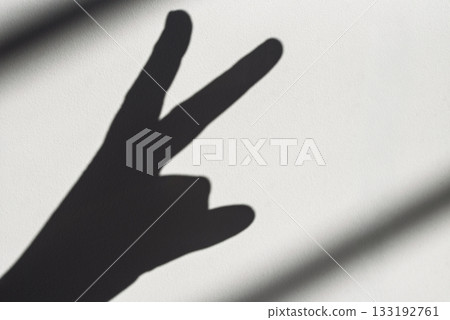 A hand is shown in a shadow, with the fingers pointing to the number three A hand is shown in a shadow, with the fingers pointing to the number three 133192761