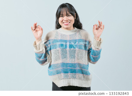 Smiling female interpreter gesturing OK in sign language. Smiling asian girl gesturing okay in language nonverbal Smiling female interpreter gesturing OK in sign language. Smiling asian girl gesturing okay in language nonverbal 133192843