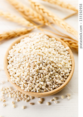Closeup of barley grains in wooden cup. Closeup of barley grains in wooden cup. 133192958