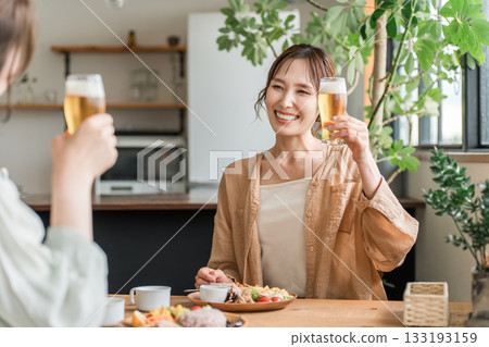 Young Asian women having a girls' party at a cafe or home (daytime drinking, beer, toasting, relaxing) 133193159