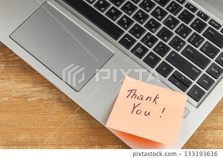 Simple thank you note placed on laptop at home workspace 133193616