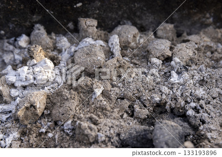 burnt coals from logs with a lot of dust and fumes, dust and burnt coals after cooking meat in the grill 133193896