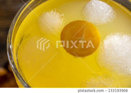 citrus-flavored orange juice and fresh kumquat fruits on a wooden table, delicious and fresh orange juice close up citrus-flavored orange juice and fresh kumquat fruits on a wooden table, delicious and fresh orange juice close up 133193906
