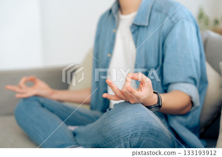 Happy young Asian man practicing yoga and meditation at home Happy young Asian man practicing yoga and meditation at home 133193912