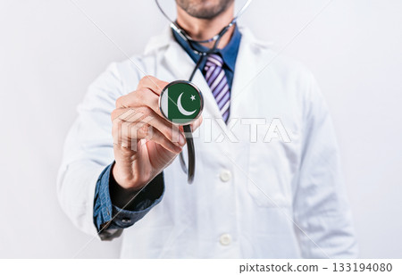Pakistan healthcare system, doctor holding stethoscope. Pakistan health and medical insurance concept Pakistan healthcare system, doctor holding stethoscope. Pakistan health and medical insurance concept 133194080