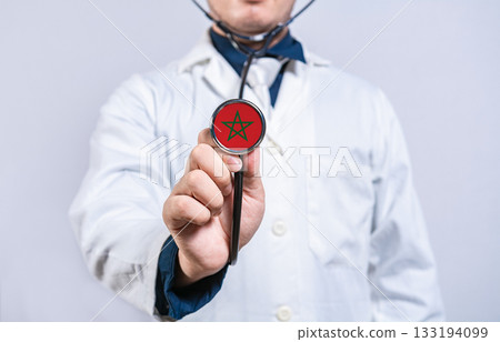Healthcare worker holding stethoscope with Morocco flag. Morocco health and care concept 133194099