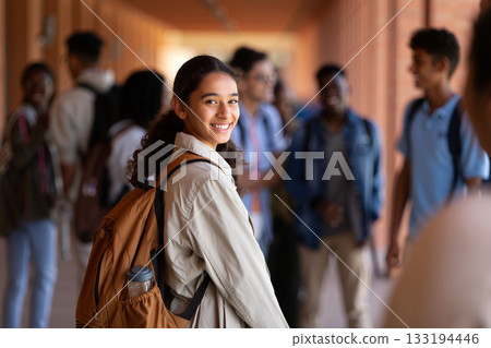 Students Socializing in a School Hallway With a Girl Smiling at the Camera During a Sunny Afternoon 133194446