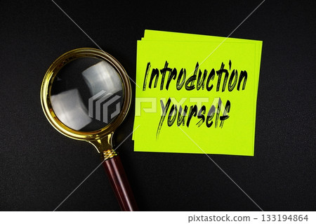 Introduction Yourself text on sticky note with magnifying glass on black background 133194864