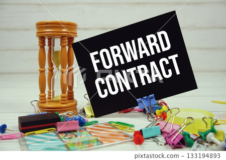 Forward Contract text on paper card with stationary on wooden background Forward Contract text on paper card with stationary on wooden background 133194893