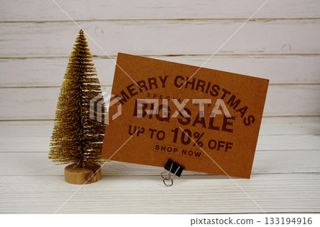 Festive display with small decorative Christmas trees with "Special Offer Merry Christmas Big Sale up to 10% off, Promotion Holiday Sale Event Festive display with small decorative Christmas trees with "Special Offer Merry Christmas Big Sale up to 10% off, Promotion Holiday Sale Event 133194916