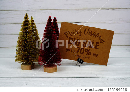 Festive display with small decorative Christmas trees with "Special Offer Merry Christmas Big Sale up to 70% off, Promotion Holiday Sale Event Festive display with small decorative Christmas trees with "Special Offer Merry Christmas Big Sale up to 70% off, Promotion Holiday Sale Event 133194918
