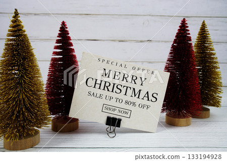 Festive display with small decorative Christmas trees with "Special Offer Merry Christmas Big Sale up to 80% off, Promotion Holiday Sale Event Festive display with small decorative Christmas trees with "Special Offer Merry Christmas Big Sale up to 80% off, Promotion Holiday Sale Event 133194928
