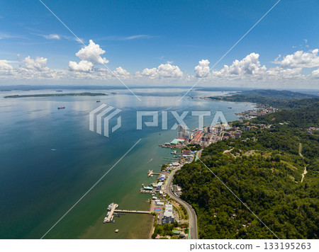 City of Sandakan on the seashore on the island of Borneo view from above. Malaysia. City of Sandakan on the seashore on the island of Borneo view from above. Malaysia. 133195263