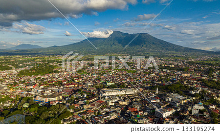 Aerial view of city of Bukittinggi and Mount Marapi. A clock tower Jam Gadang. Sumatra. Indonesia. Aerial view of city of Bukittinggi and Mount Marapi. A clock tower Jam Gadang. Sumatra. Indonesia. 133195274