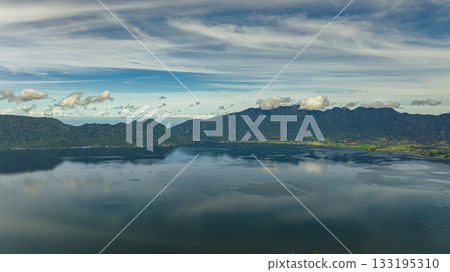 Blue lake Maninjau in a crater among the mountains. Sumatra, Indonesia. Blue lake Maninjau in a crater among the mountains. Sumatra, Indonesia. 133195310
