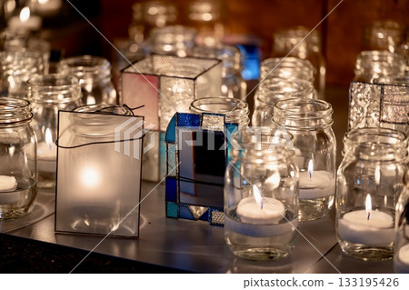 A relaxing space with glowing candles and glass decorations at night 133195426