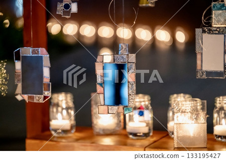 A relaxing space with glowing candles and glass decorations at night 133195427