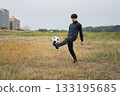 A man practicing soccer juggling 133195685