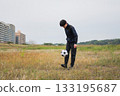 A man practicing soccer juggling 133195687