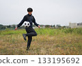 Man kicking a soccer ball 133195692