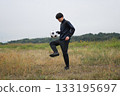 A man practicing soccer juggling 133195697