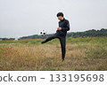 A man practicing soccer juggling 133195698