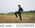 A man practicing soccer juggling 133195699