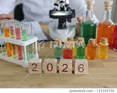 Lab setup with colorful test tubes, vials, and microscope displaying experiments for 2026 Lab setup with colorful test tubes, vials, and microscope displaying experiments for 2026 133195730