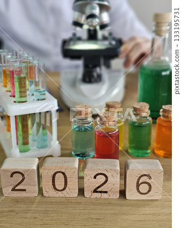 Bright colorful laboratory setup showing bottles, test tubes, and a microscope for scientific experiments in 2026 concept 133195731