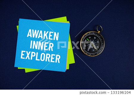 Awaken Inner Explorer text written on sticky note with compass on blue background Awaken Inner Explorer text written on sticky note with compass on blue background 133196104