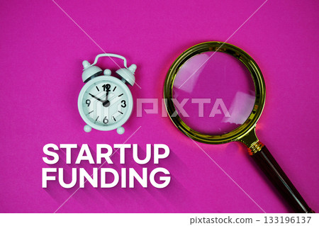 Alarm clock and a magnifying glass on a bright pink background, with text "Startup Funding" Alarm clock and a magnifying glass on a bright pink background, with text "Startup Funding" 133196137