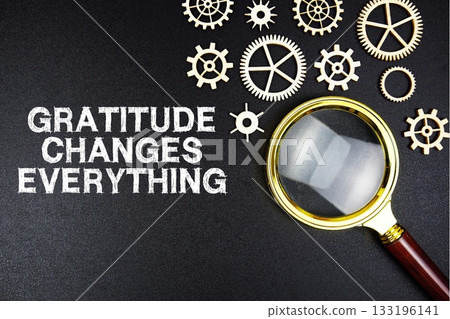 Gratitude Changes Everything text message with magnifying glass on black background 133196141