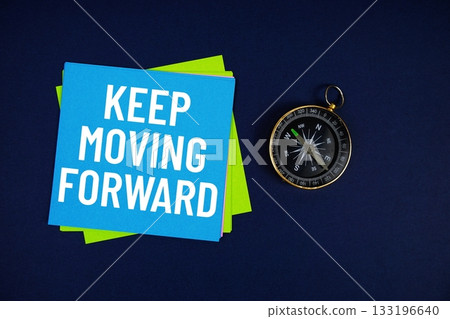 Keep Moving Forward text written on sticky note with compass on blue  background 133196640
