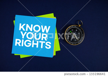 Know Your Rights text written on sticky note with compass on blue background Know Your Rights text written on sticky note with compass on blue background 133196641