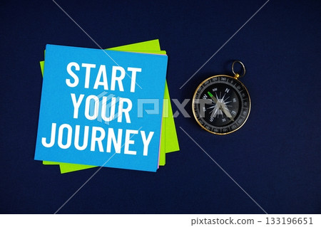 Start Your Journey text written on sticky note with compass on blue background Start Your Journey text written on sticky note with compass on blue background 133196651