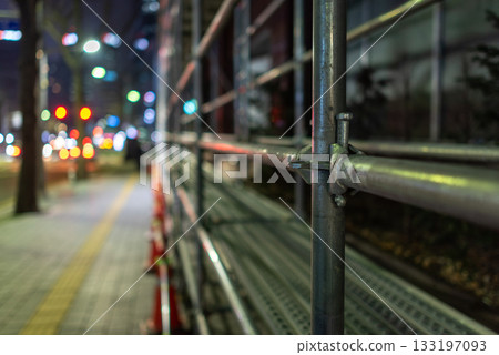 Nighttime Urban street scene with scaffolding and traffic lights Nighttime Urban street scene with scaffolding and traffic lights 133197093