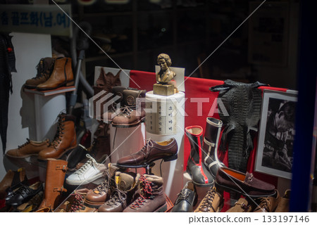 Shoe shop window display featuring various vintage leather shoes and boots in Seoul, South Korea 133197146