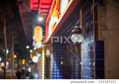 Street scene with blue-tiled wall and vintage lamp at night in Seoul, South Korea 133197151