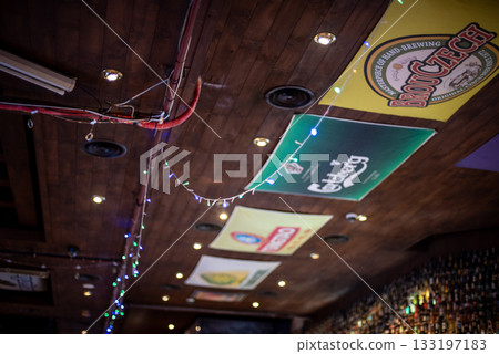 Ceiling of a bar with beer brand signs and string lights in Seoul, South Korea Ceiling of a bar with beer brand signs and string lights in Seoul, South Korea 133197183