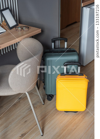 Luggage standing in hotel room ready for travel 133197216