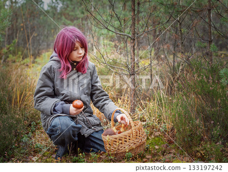 Young girl mushroom picking in autumn forest 133197242
