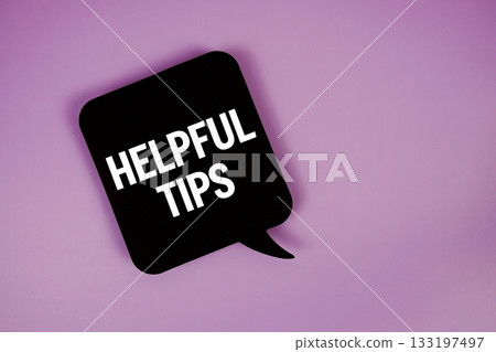 Helpful Tips text with speech bubble top view on purple background 133197497