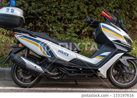 Korean Police motorcycle parked on a street with trees in the background, in Seoul, South Korea 133197616