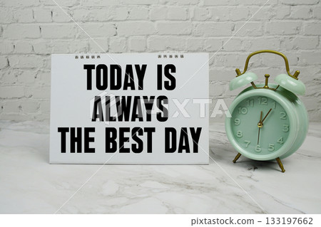 Today is always the best day with green vintage alarm clock against a white brick wall background Today is always the best day with green vintage alarm clock against a white brick wall background 133197662
