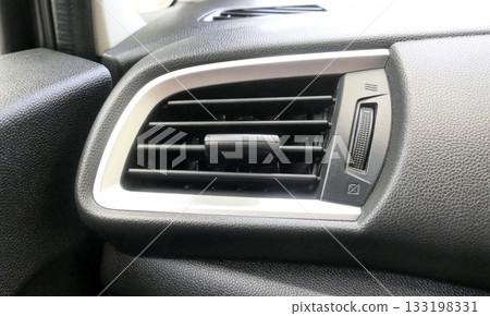 Air vents in the front of the car next to the driver 133198331