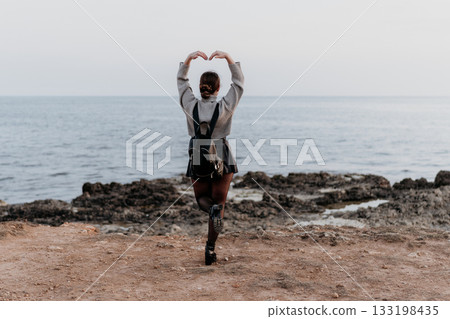Woman Ocean Heart-shape Pose: Coastal Love Gesture Photography Woman Ocean Heart-shape Pose: Coastal Love Gesture Photography 133198435