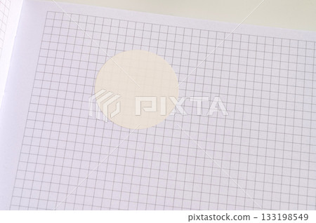 White circle sticker on grid paper background White circle sticker on grid paper background 133198549