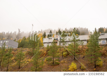 Misty autumn landscape with modern buildings and dense forest Misty autumn landscape with modern buildings and dense forest 133198562