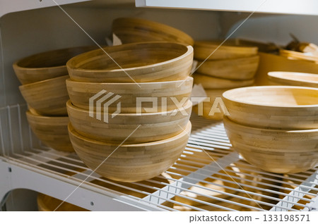 Wooden bamboo bowls on display shelf in kitchenware store Wooden bamboo bowls on display shelf in kitchenware store 133198571